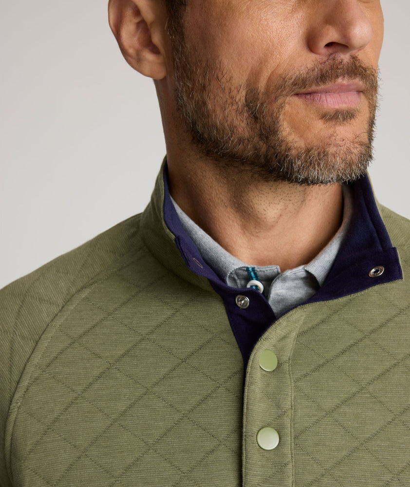 Model is wearing UNTUCKit Garrison pullover in olivine. 
