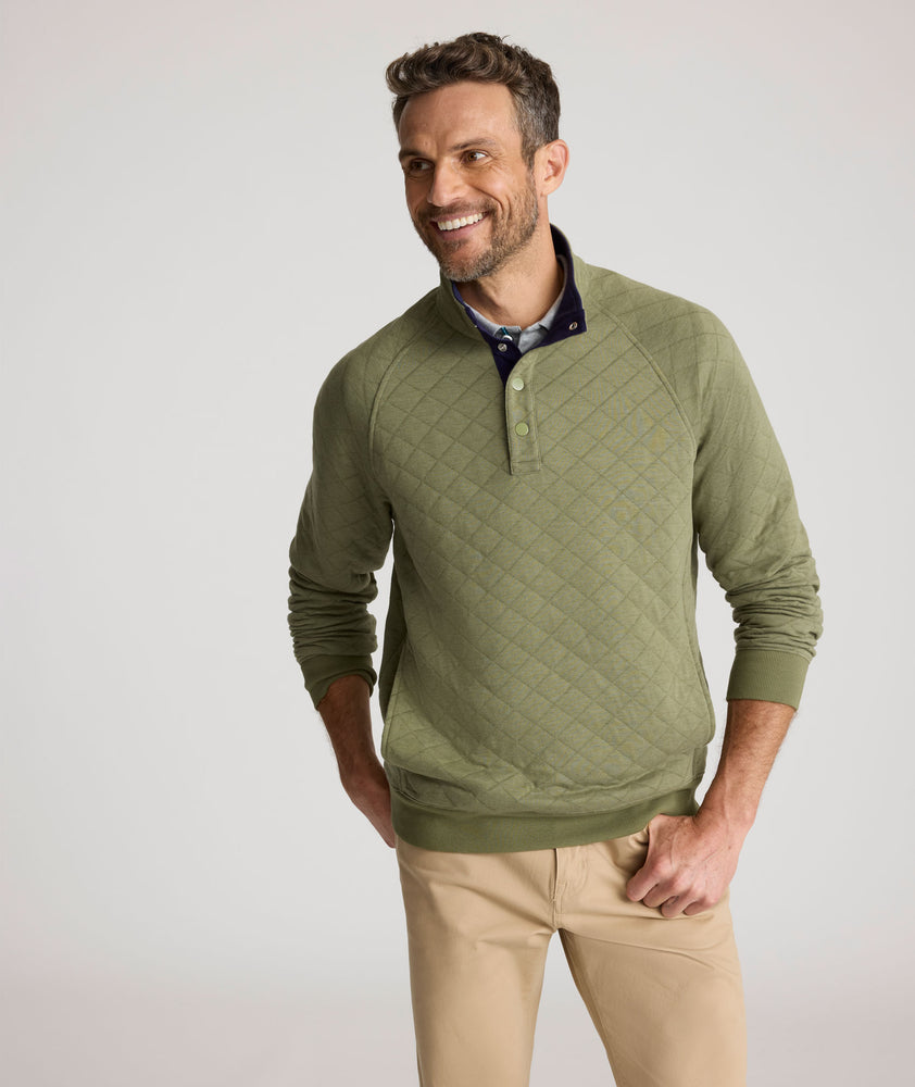 Model is wearing UNTUCKit Garrison pullover in olivine. 