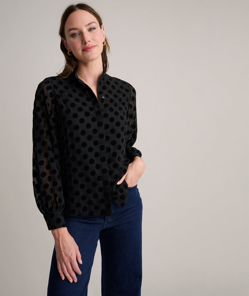 Model is wearing UNTUCKit Gemma shirt in black polka dot. 