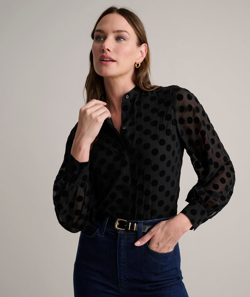 Model is wearing UNTUCKit Gemma shirt in black polka dot. 