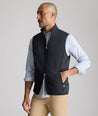 Model is wearing UNTUCKit Performance Packable Vest in black. 