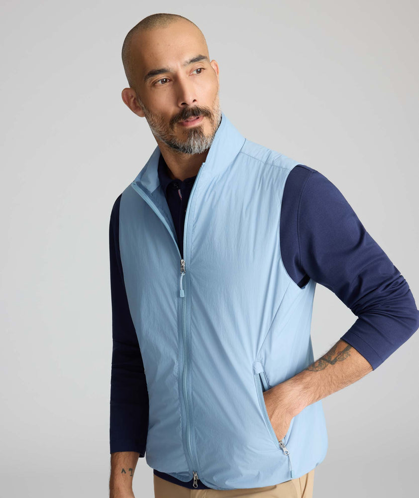 Model wearing a blue packable vest.