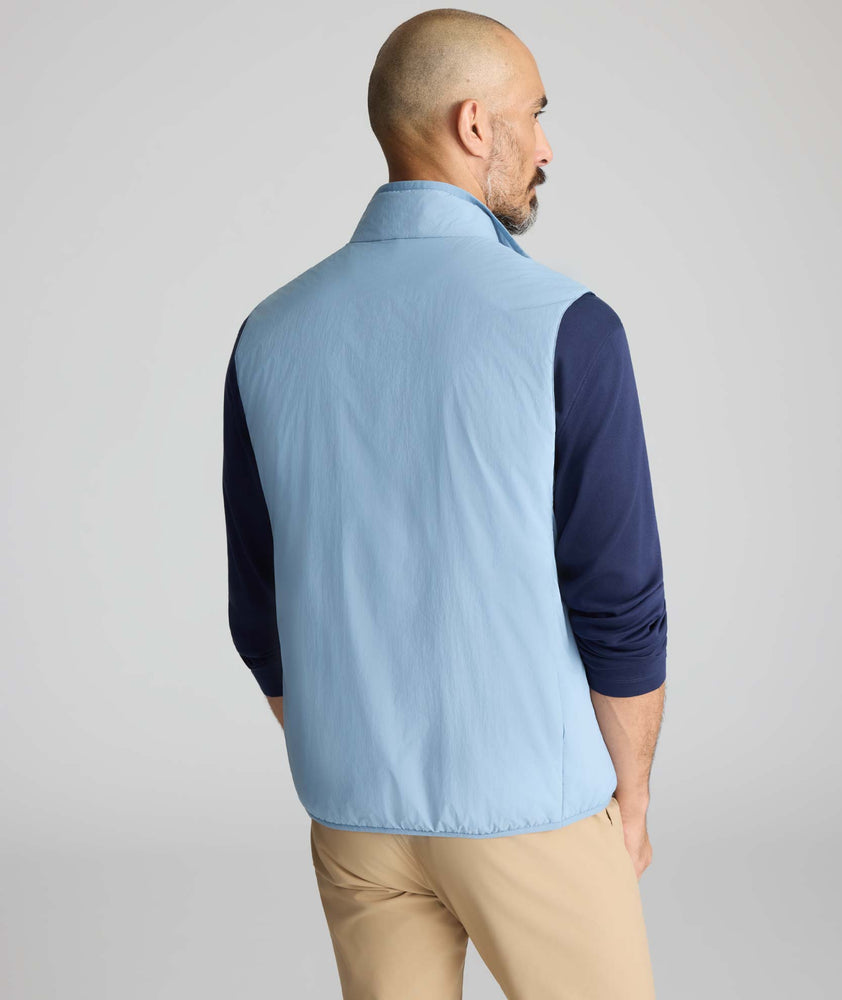 Model wearing a blue packable vest.