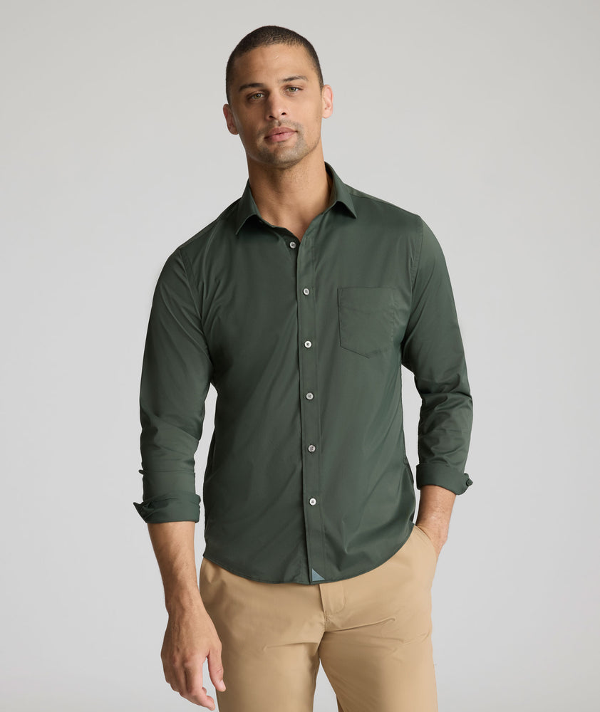 Model is wearing UNTUCKit Gironde performance shirt in Kombu green. 