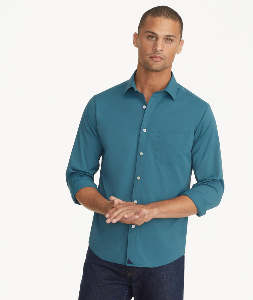 Model is wearing UNTUCKit Wrinkle-Free Performance Gironde Shirt in Deep Green.
