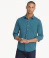 Model is wearing UNTUCKit Wrinkle-Free Performance Gironde Shirt in Deep Green.