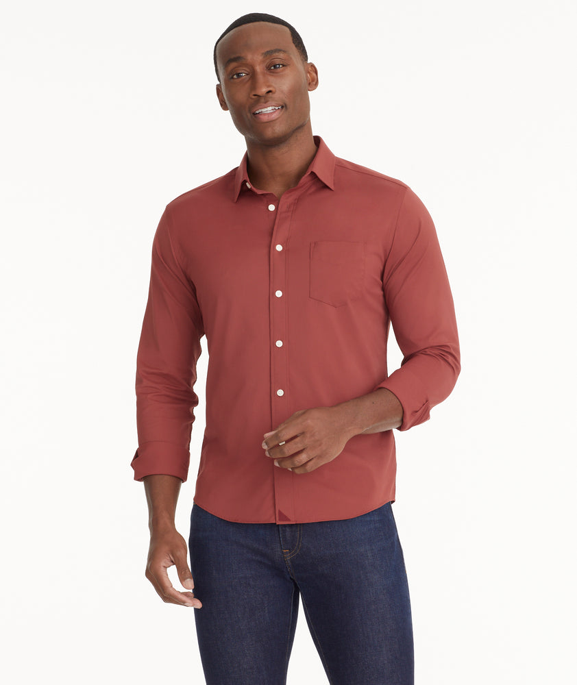 Model is wearing UNTUCKit Wrinkle-Free Performance Gironde Shirt in fired brick.