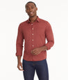 Model is wearing UNTUCKit Wrinkle-Free Performance Gironde Shirt in fired brick.