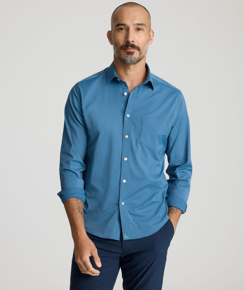 Model is wearing UNTUCKit Gironde performance shirt in real teal. 