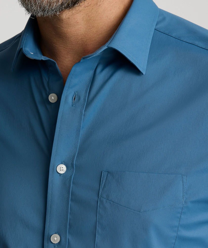 Model is wearing UNTUCKit Gironde performance shirt in real teal. 