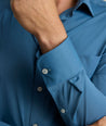 Model is wearing UNTUCKit Gironde performance shirt in real teal. 