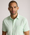 Model is wearing UNTUCKit Gironde short sleeve performance  shirt in bright green. 