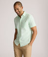 Model is wearing UNTUCKit Gironde short sleeve performance  shirt in bright green. 