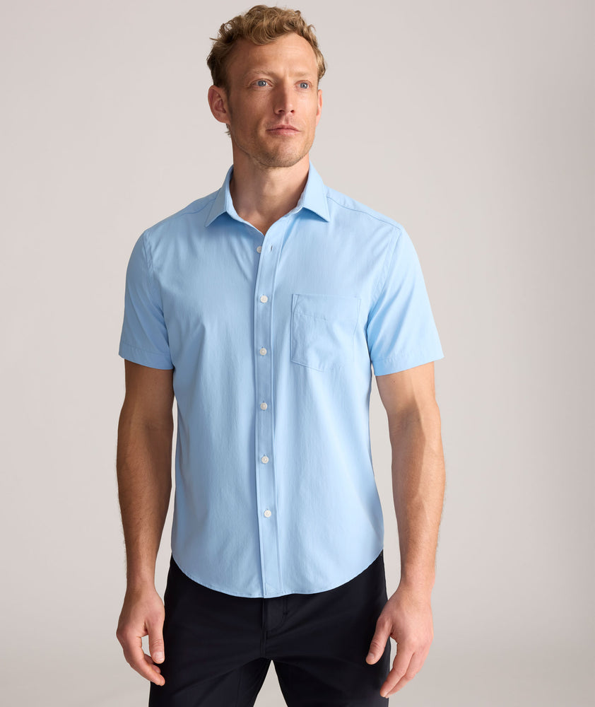 Model is wearing UNTUCKit Performance Gironde Shirt in light blue. 