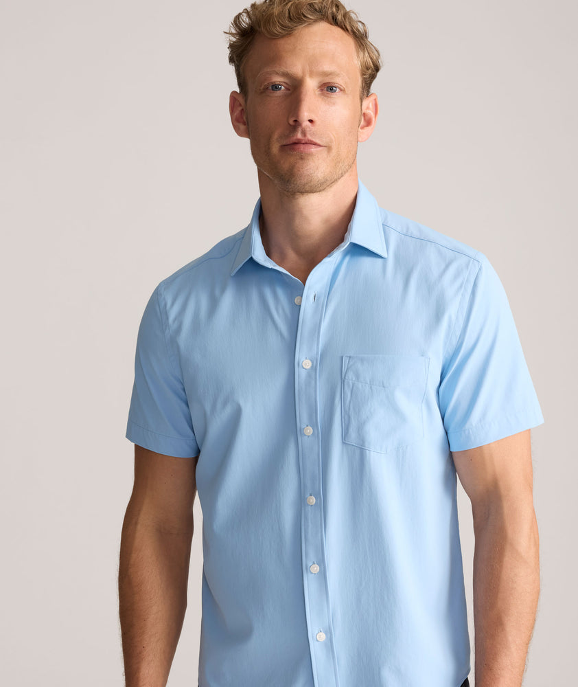 Model is wearing UNTUCKit Performance Gironde Shirt in light blue. 
