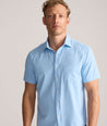 Model is wearing UNTUCKit Performance Gironde Shirt in light blue. 