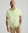 Model is wearing UNTUCKit Performance Short-Sleeve Gironde Shirt in bright green. 