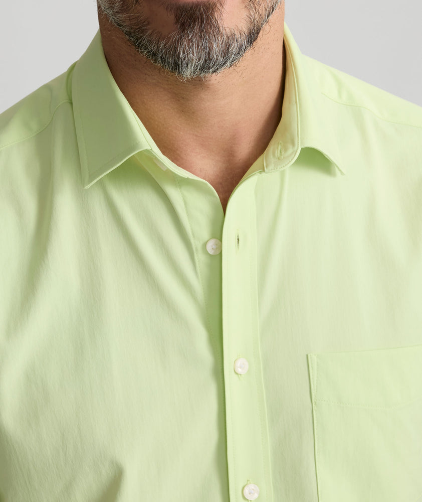 Model is wearing UNTUCKit Performance Short-Sleeve Gironde Shirt in bright green. 