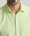 Model is wearing UNTUCKit Performance Short-Sleeve Gironde Shirt in bright green. 