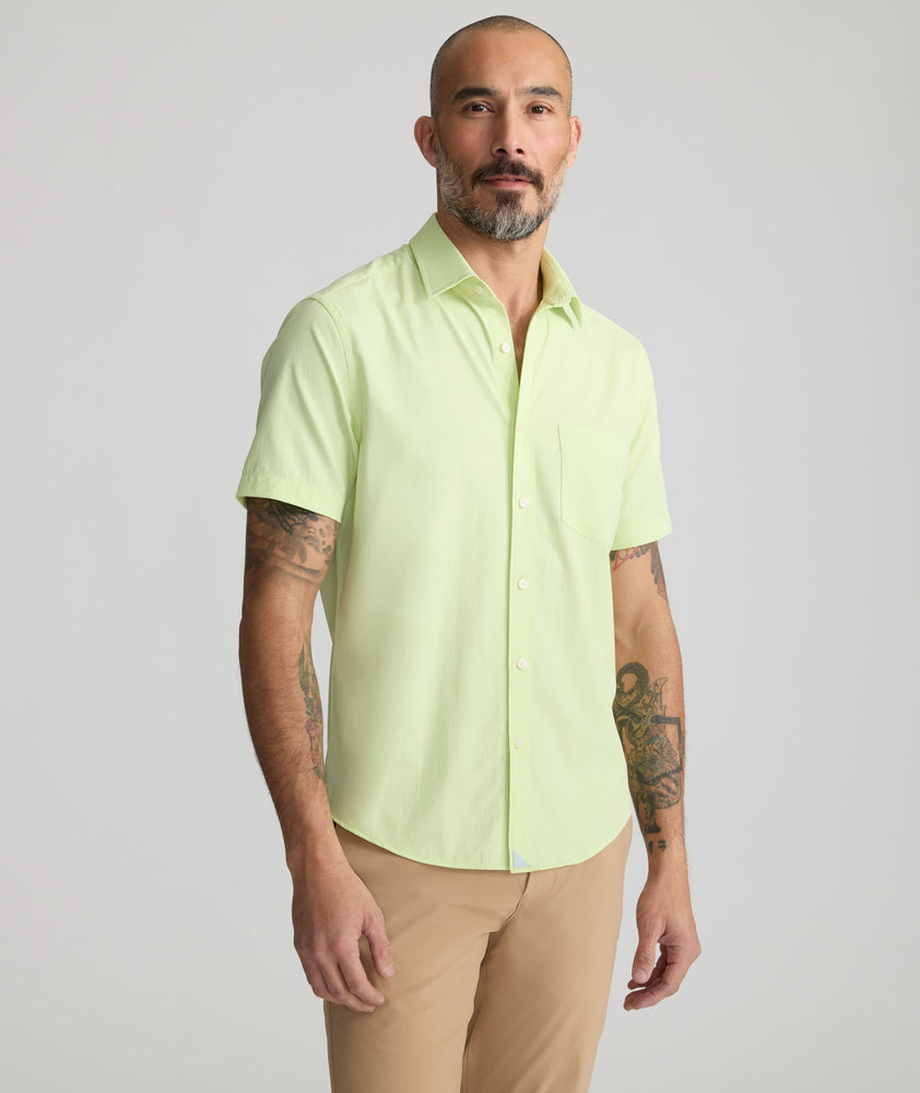 Model is wearing UNTUCKit Performance Short-Sleeve Gironde Shirt in bright green. 