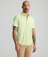 Model is wearing UNTUCKit Performance Short-Sleeve Gironde Shirt in bright green. 