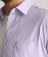 Model is wearing UNTUCKit Gironde short sleeve performance  shirt in purple. 