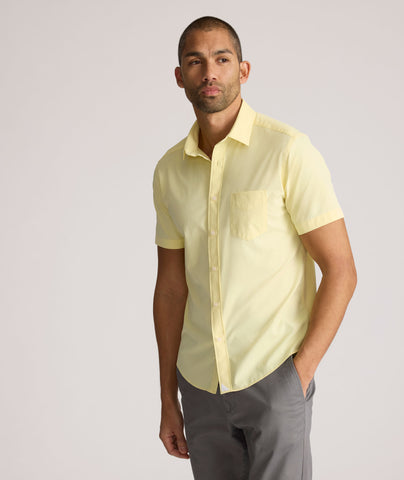 Model is wearing UNTUCKit Gironde short sleeve performance  shirt in light yellow. 