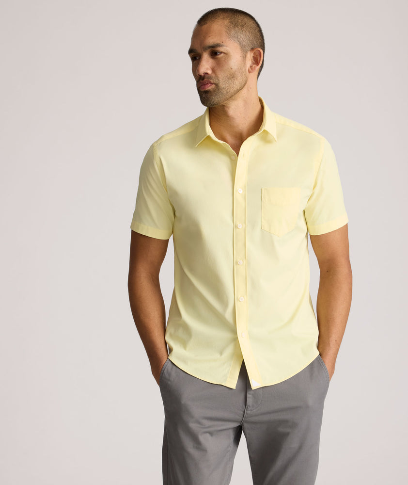Model is wearing UNTUCKit Gironde short sleeve performance  shirt in light yellow. 