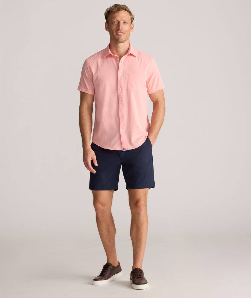 Model is wearing UNTUCKit Performance Gironde Shirt in pink.