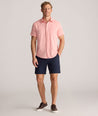 Model is wearing UNTUCKit Performance Gironde Shirt in pink.