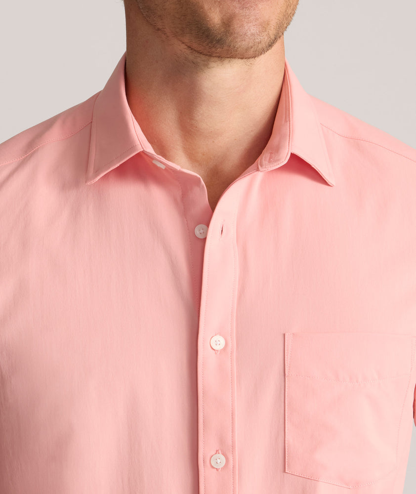 Model is wearing UNTUCKit Performance Gironde Shirt in pink.