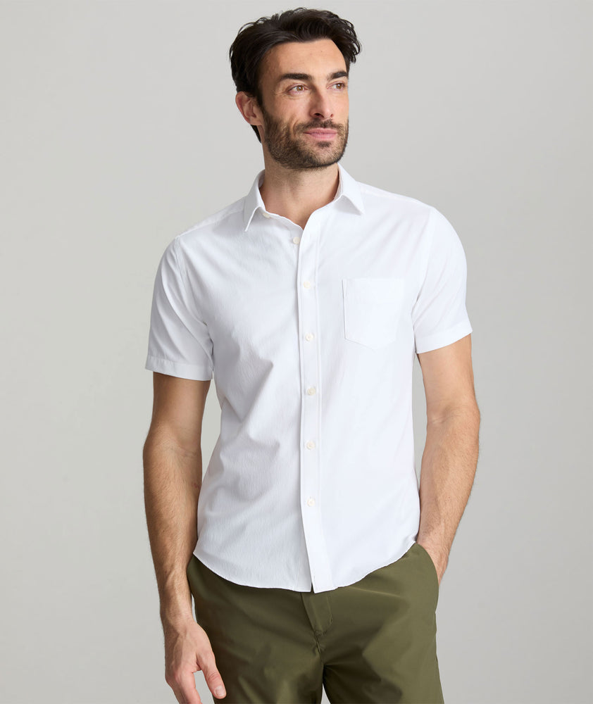 Model wearing an UNTUCKit White Wrinkle-Free Performance Short Sleeve Gironde Shirt