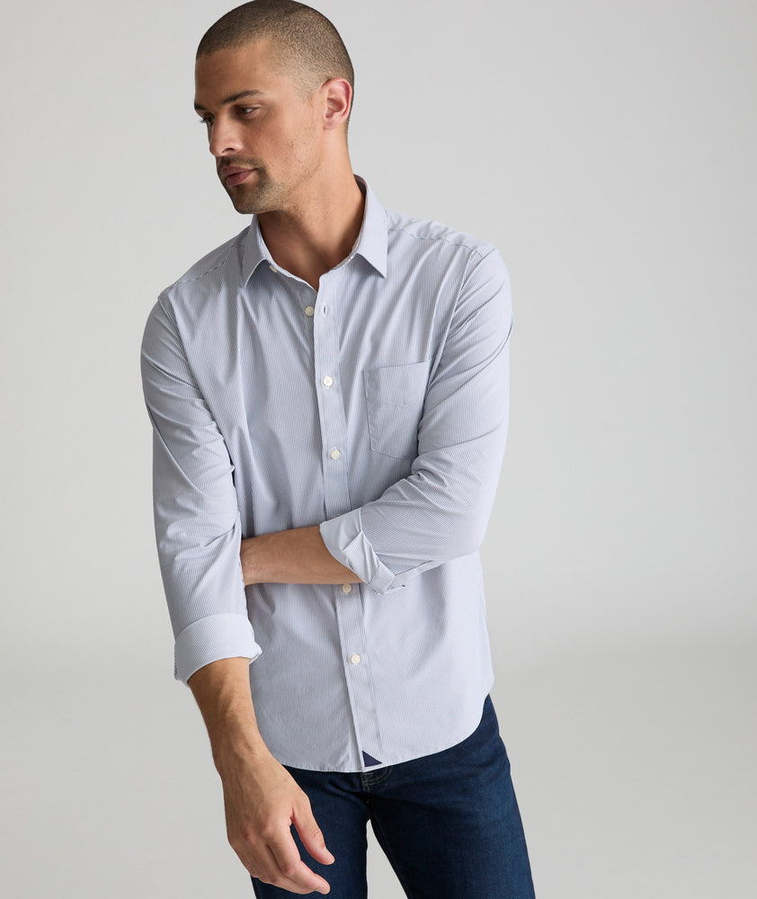 Model is wearing UNTUCKit gironde performance shirt in blue stripe.