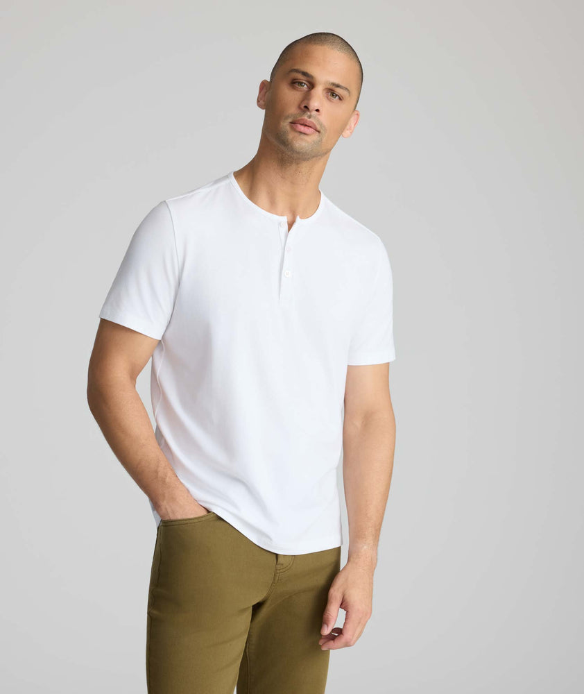 Model wearing a white short-sleeve henley