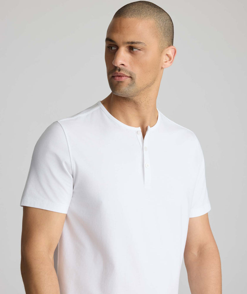 Model wearing a white short-sleeve henley