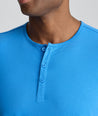 Model is wearing UNTUCKit EcoSoft Short-Sleeve Henley in light blue. 