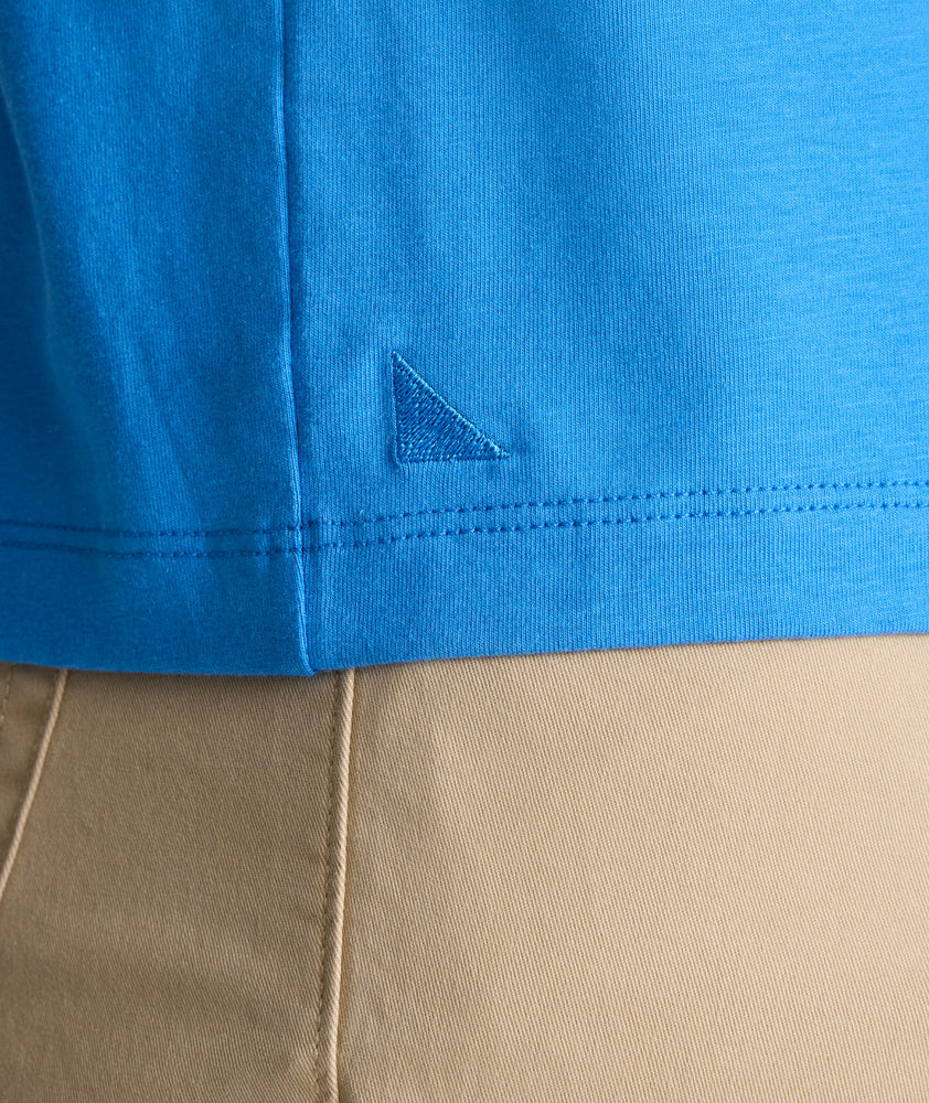 Model is wearing UNTUCKit EcoSoft Short-Sleeve Henley in light blue. 