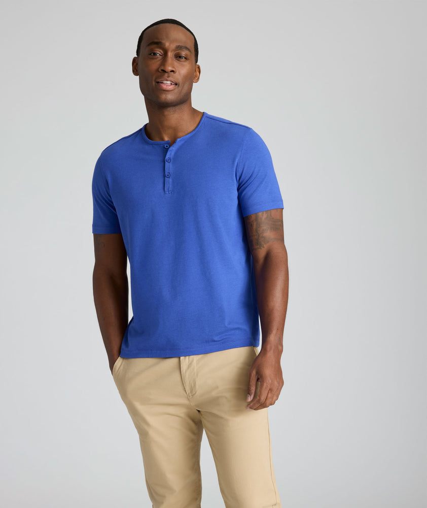 Model is wearing UNTUCKit Glera henley in deep ultramarine. 