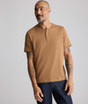 Model is wearing UNTUCKit EcoSoft Short-Sleeve Henley in toasted coconut. 