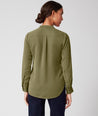 Model is wearing UNTUCKit Gloria shirt in olive.