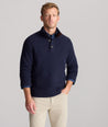Model is wearing UNTUCKit Button-Neck Donegal Sweater in navy.