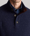 Model is wearing UNTUCKit Button-Neck Donegal Sweater in navy.