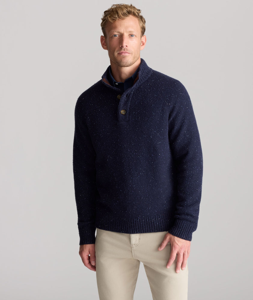 Model is wearing UNTUCKit Button-Neck Donegal Sweater in navy.