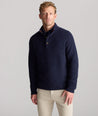 Model is wearing UNTUCKit Button-Neck Donegal Sweater in navy.
