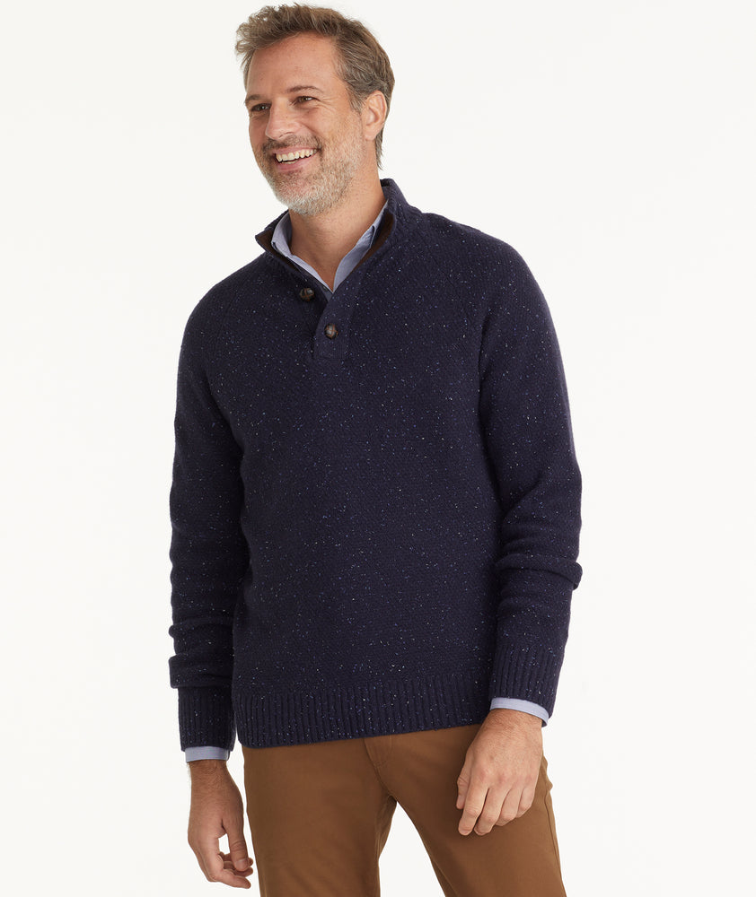 Model is wearing UNTUCKit Button-Neck Donegal Sweater in navy.