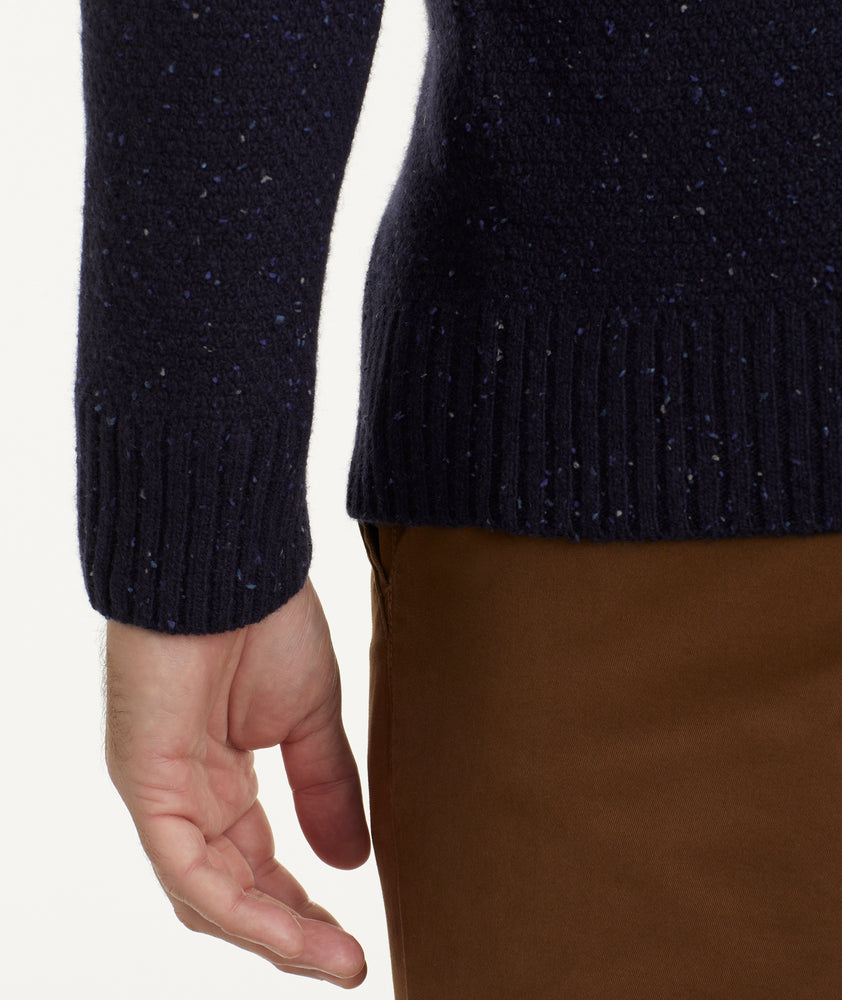 Model is wearing UNTUCKit Button-Neck Donegal Sweater in navy.