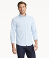 Model is wearing UNTUCKit Wrinkle-Free Performance Griffin Shirt in Light Blue Subtle Check.