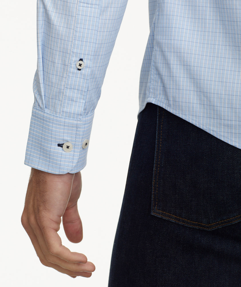 Model is wearing UNTUCKit Wrinkle-Free Performance Griffin Shirt in Light Blue Subtle Check.