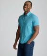 Model is wearing UNTUCKit Halloway shirt in teal. 