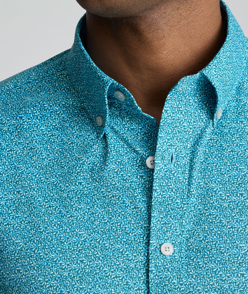 Model is wearing UNTUCKit Halloway shirt in teal. 